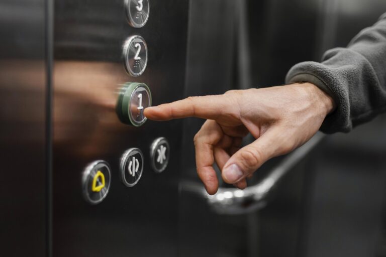 delivery-man-with-package-elevator-close-up-scaled